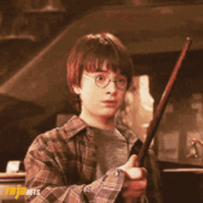 A Young Boy In A Plaid Shirt Is Holding A Wand In His Hand GIF