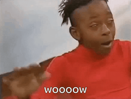 A Young Boy In A Red Shirt Is Making A Funny Face And Says Wooow . GIF