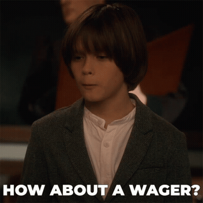 A Young Boy In A Suit And White Shirt Is Asking How About A Wager GIF