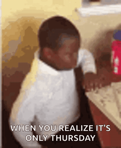A Young Boy In A White Shirt And Tie Is Sitting At A Table With The Words When You Realize It 'S Only Thursday GIF