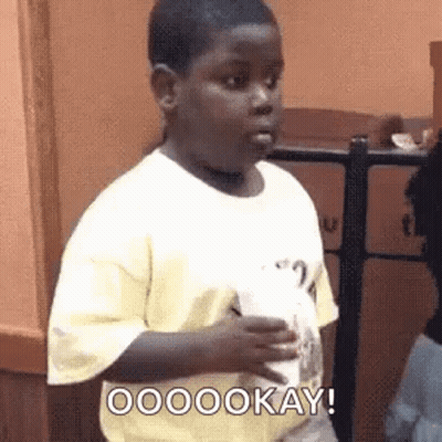A Young Boy In A Yellow Shirt Is Holding A Cup And Making A Face . GIF