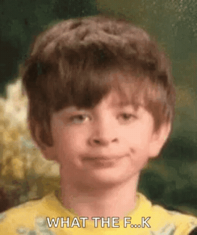 A Young Boy In A Yellow Shirt Is Making A Funny Face And Says `` What The F ... K '' . GIF