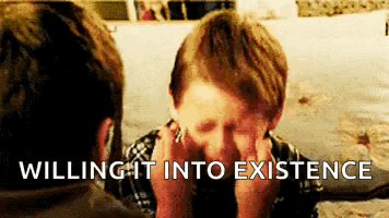 A Young Boy Is Covering His Face With His Hands And The Words Willing It Into Existence Are Written Above Him . GIF