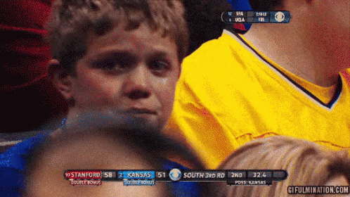 A Young Boy Is Crying While Watching A Sports Game Between Stanford And Kansas GIF