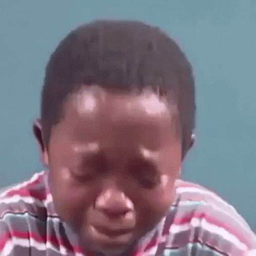 A Young Boy Is Crying With His Eyes Closed . GIF