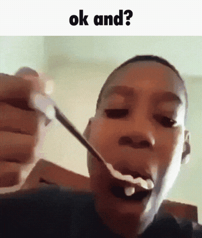 A Young Boy Is Eating A Spoonful Of Cereal With The Words Ok And Written Above Him . GIF