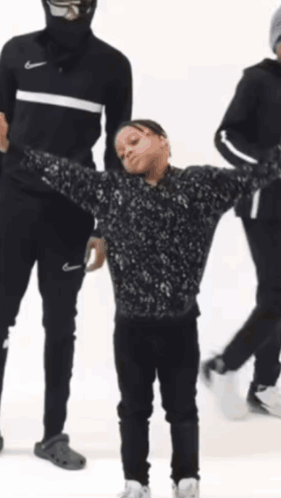 A Young Boy Is Holding A Bottle That Says 99 % Juice GIF