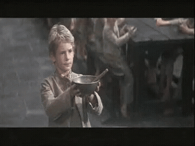 A Young Boy Is Holding A Bowl Of Soup With A Spoon In His Hand . GIF