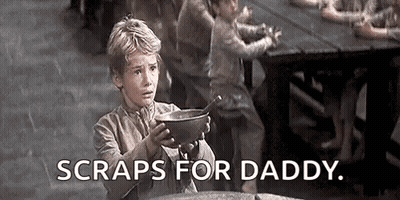 A Young Boy Is Holding A Bowl Of Soup With The Words `` Scraps For Daddy '' . GIF