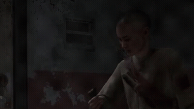 A Young Boy Is Holding A Flashlight In His Hand In A Dark Room . GIF