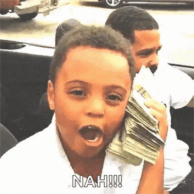 A Young Boy Is Holding A Large Stack Of Money In His Hand . GIF
