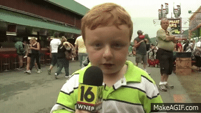 A Young Boy Is Holding A Microphone That Says 16 On It GIF
