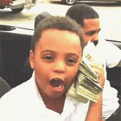 A Young Boy Is Holding A Stack Of Money In His Hand And Making A Funny Face . GIF