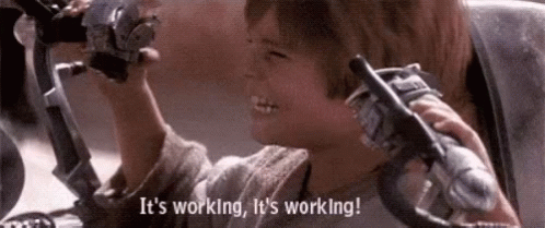 A Young Boy Is Holding A Steering Wheel And Saying `` It 'S Working , It 'S Working '' . GIF