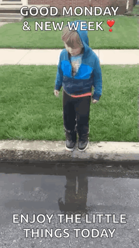 A Young Boy Is Jumping Into A Puddle Of Water . GIF