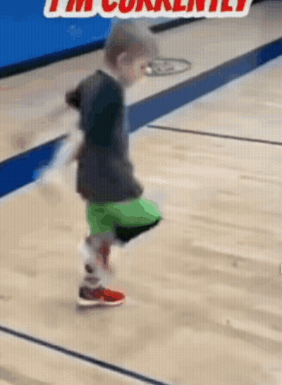 A Young Boy Is Kicking A Ball On A Basketball Court And The Caption Says I 'M Currently . GIF