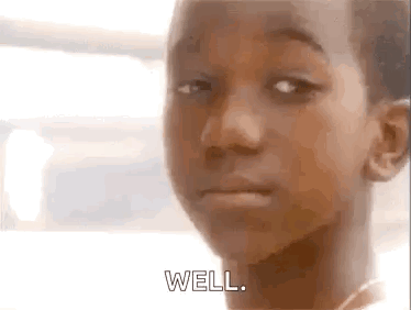 A Young Boy Is Making A Face And Saying `` Well '' . GIF
