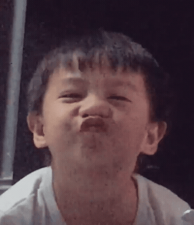 A Young Boy Is Making A Funny Face And Making A Funny Face With His Mouth Open . GIF