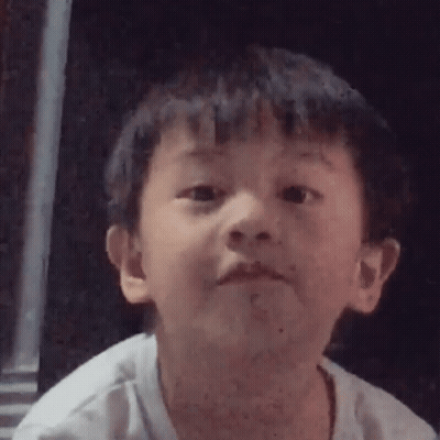 A Young Boy Is Making A Funny Face In A Close Up Of His Face . GIF