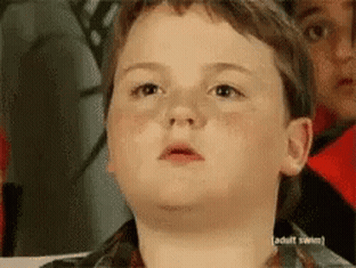 A Young Boy Is Making A Funny Face In Front Of A Sign That Says " Adult Swim " GIF