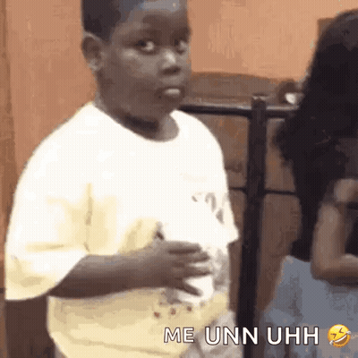 A Young Boy Is Making A Funny Face While Holding A Cup Of Coffee In His Hand . GIF