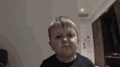 A Young Boy Is Making A Funny Face While Looking At The Camera . GIF