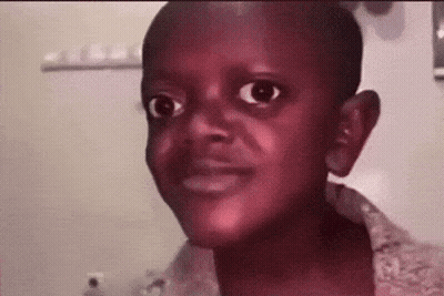 A Young Boy Is Making A Funny Face While Looking At The Camera In A Bathroom . GIF