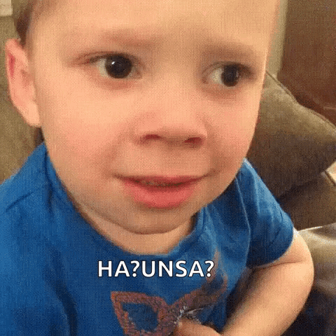 A Young Boy Is Making A Funny Face While Sitting On A Couch And Making A Funny Face . GIF
