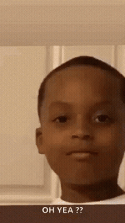 A Young Boy Is Making A Funny Face While Standing In Front Of A Window . GIF