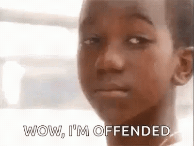 A Young Boy Is Making A Funny Face With The Words Wow , I 'M Offended . GIF