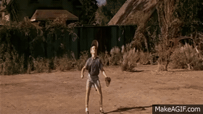 A Young Boy Is Playing Baseball In A Dirt Field With Makeagif.com Written On The Bottom Of The Screen GIF