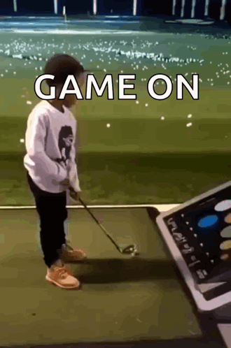 A Young Boy Is Playing Golf With The Words Game On Written Above Him GIF