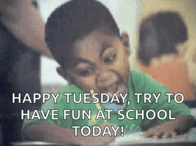 A Young Boy Is Sitting At A Desk In A Classroom . GIF