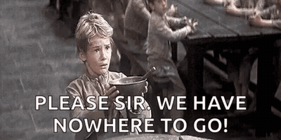 A Young Boy Is Sitting At A Table Holding A Pot Of Soup And A Spoon . GIF