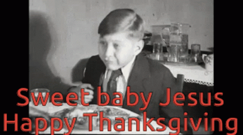 A Young Boy Is Sitting At A Table With A Plate Of Food And The Words Sweet Baby Jesus Happy Thanksgiving GIF
