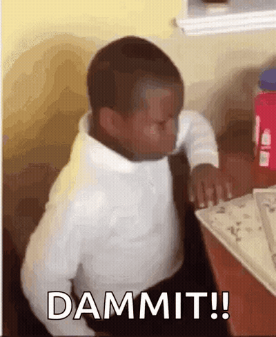 A Young Boy Is Sitting At A Table With His Eyes Closed And The Word Dammit Written On The Screen . GIF