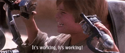 A Young Boy Is Sitting In A Chair Holding A Toy Gun . GIF