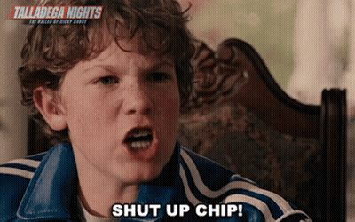 A Young Boy Is Sitting In A Chair With The Words Talladega Nights Behind Him GIF