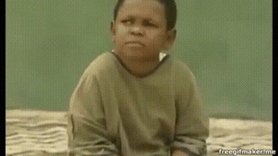 A Young Boy Is Sitting On A Bed And Making A Face . GIF