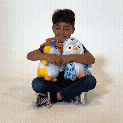 A Young Boy Is Sitting On The Floor With Two Stuffed Animals GIF