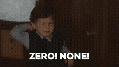 A Young Boy Is Standing In A Dark Room With His Hands Behind His Head . GIF