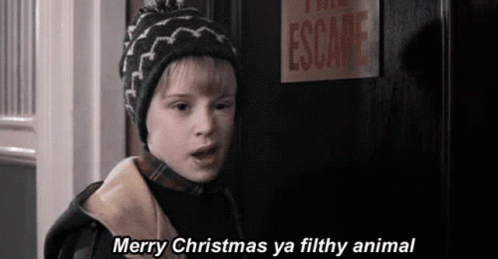 A Young Boy Is Standing In Front Of A Door With A Sign That Says Escape . GIF