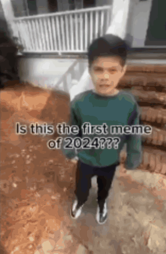 A Young Boy Is Standing In Front Of A House With The Words `` Is This The First Meme Of 2024 '' Written On It . GIF