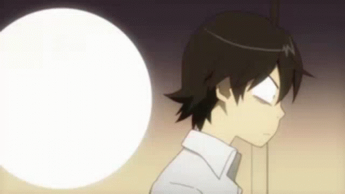 A Young Boy Is Standing In Front Of A White Ball . GIF