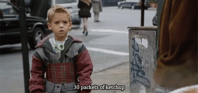 A Young Boy Is Standing On A Street With The Words 30 Packets Of Ketchup Above Him GIF