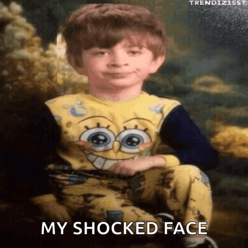 A Young Boy Is Wearing A Spongebob Pajama And Has A Surprised Look On His Face GIF