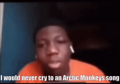 A Young Boy Is Wearing Ear Buds And Says I Would Never Cry To An Arctic Monkeys Song GIF