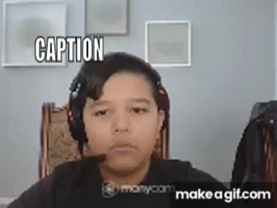 A Young Boy Is Wearing Headphones And Making A Funny Face While Sitting In A Chair . GIF