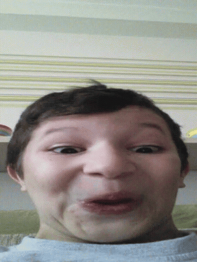 A Young Boy Making A Funny Face With His Mouth Wide Open GIF