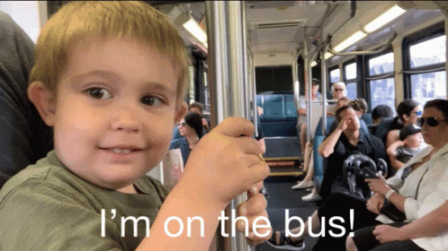 A Young Boy On A Bus With The Words " I 'M On The Bus " Below Him GIF